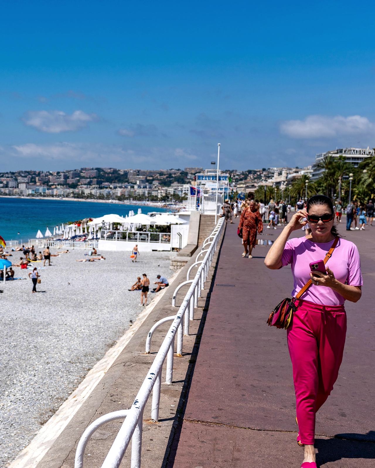 Walking the promenade above the beach in Nice at midday